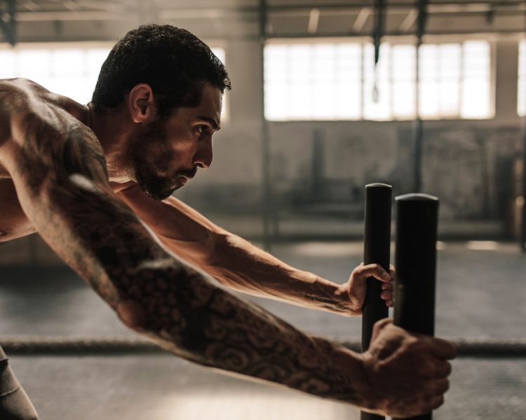 person with tattoo who is working out in a gym